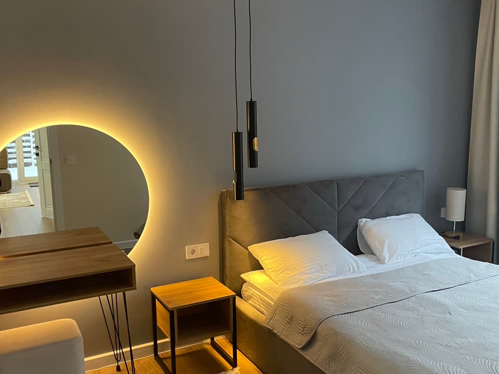 Bedroom with upholstered bed and desk
