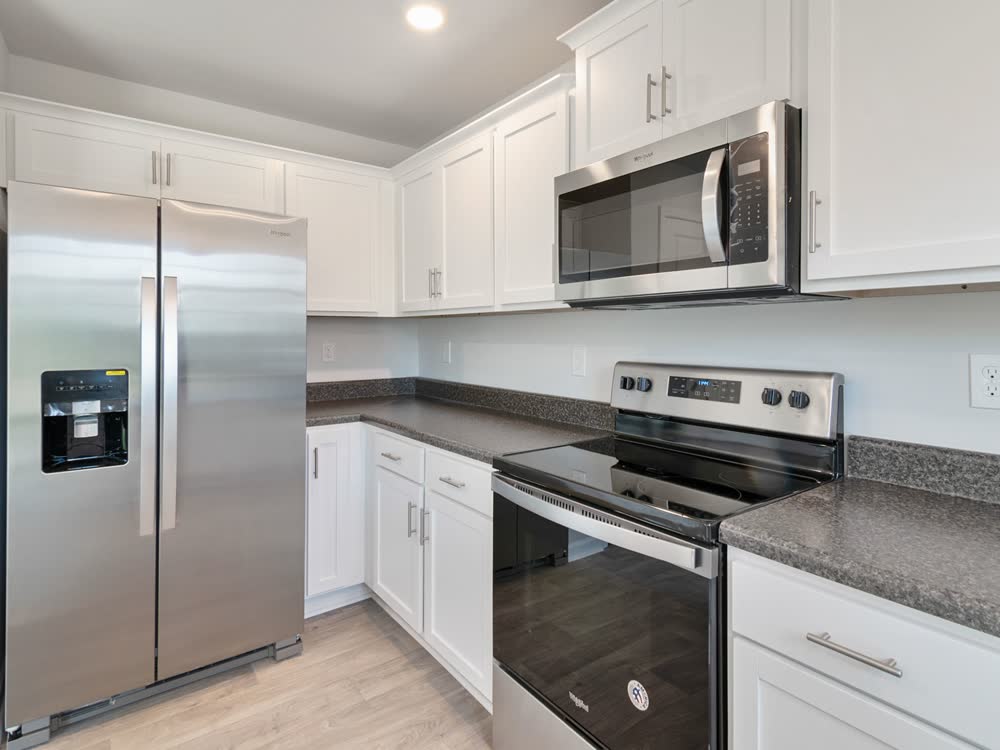 Kitchen with refrigerator, oven and microwave